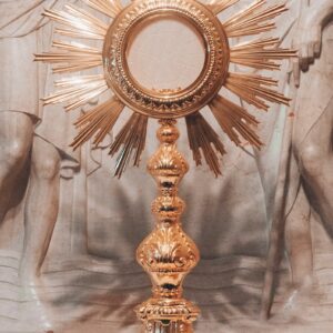 gold round framed mirror on gray textile