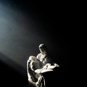 man in white and black jacket and pants sitting on black surface