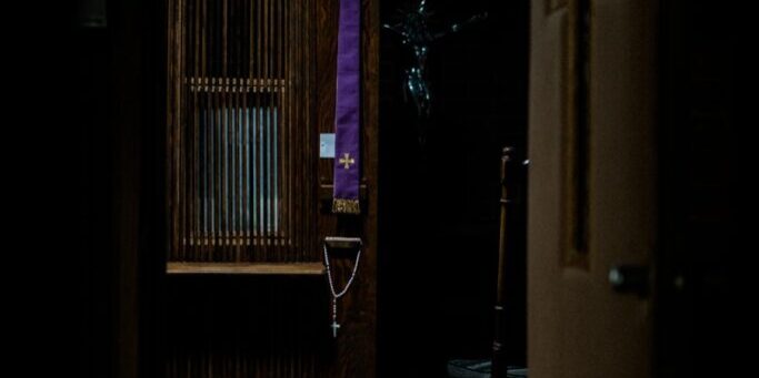brown wooden upright piano in room