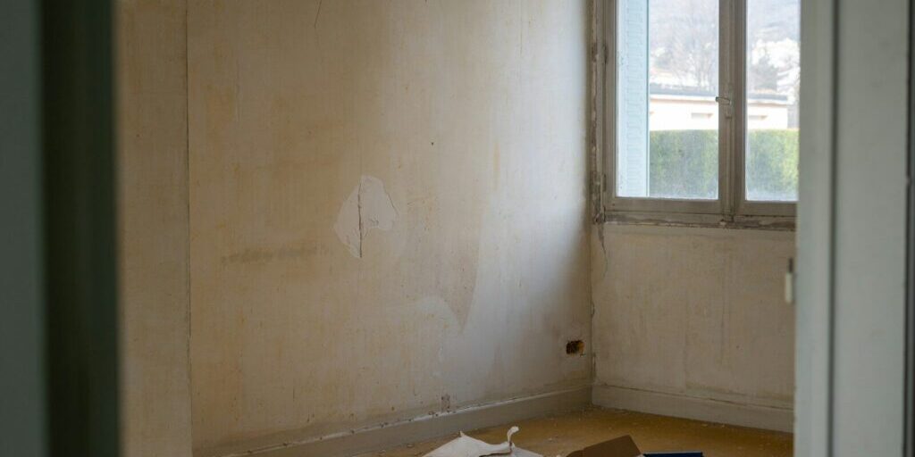 a room with a window and a bunch of items on the floor