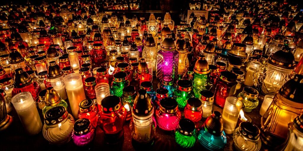 photo by ludomił sawicki a large group of colorful lit candles sitting on top of a table