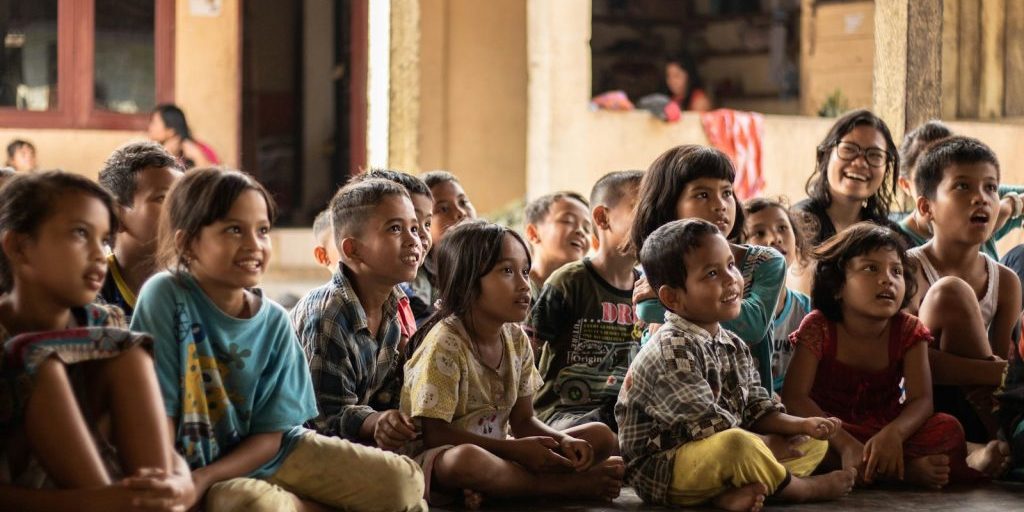 group of childrens sitting on ground