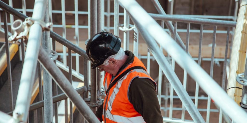 man standing under scaffoldings